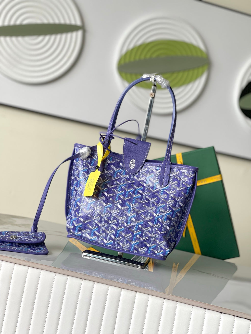 Goyard patterned tote bag in blue with leather handles and neon accessory tag