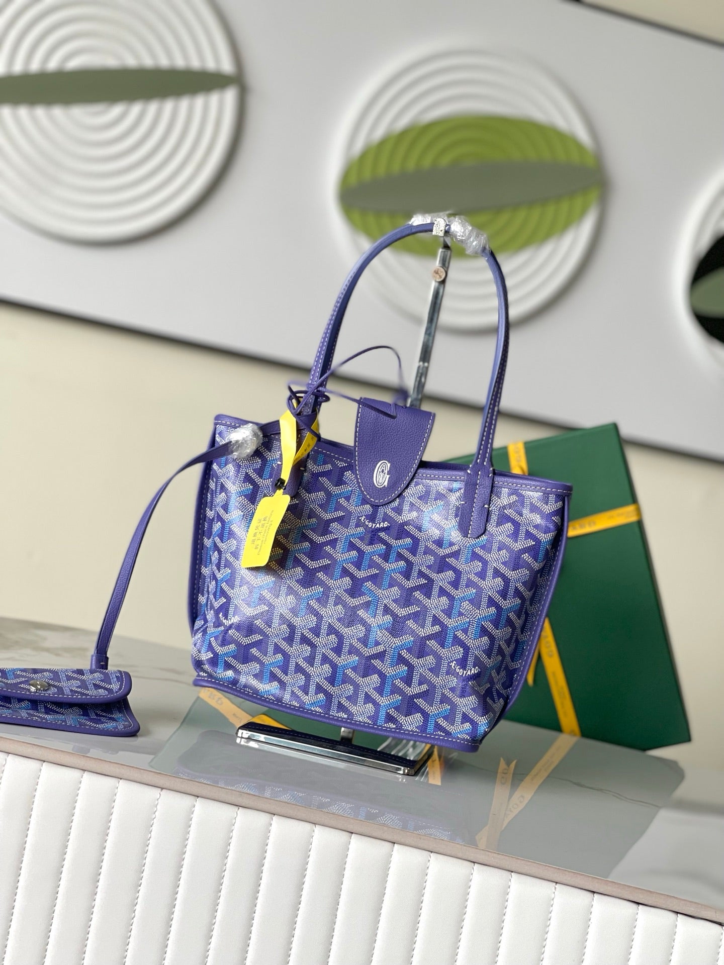 Goyard patterned tote bag in blue with leather handles and neon accessory tag