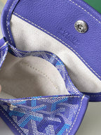 Blue patterned mini pouch inside Goyard tote, showing lining and stitch trim