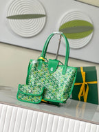 Green Goyard handbag with two top handles, patterned front, and leather-trimmed front pocket