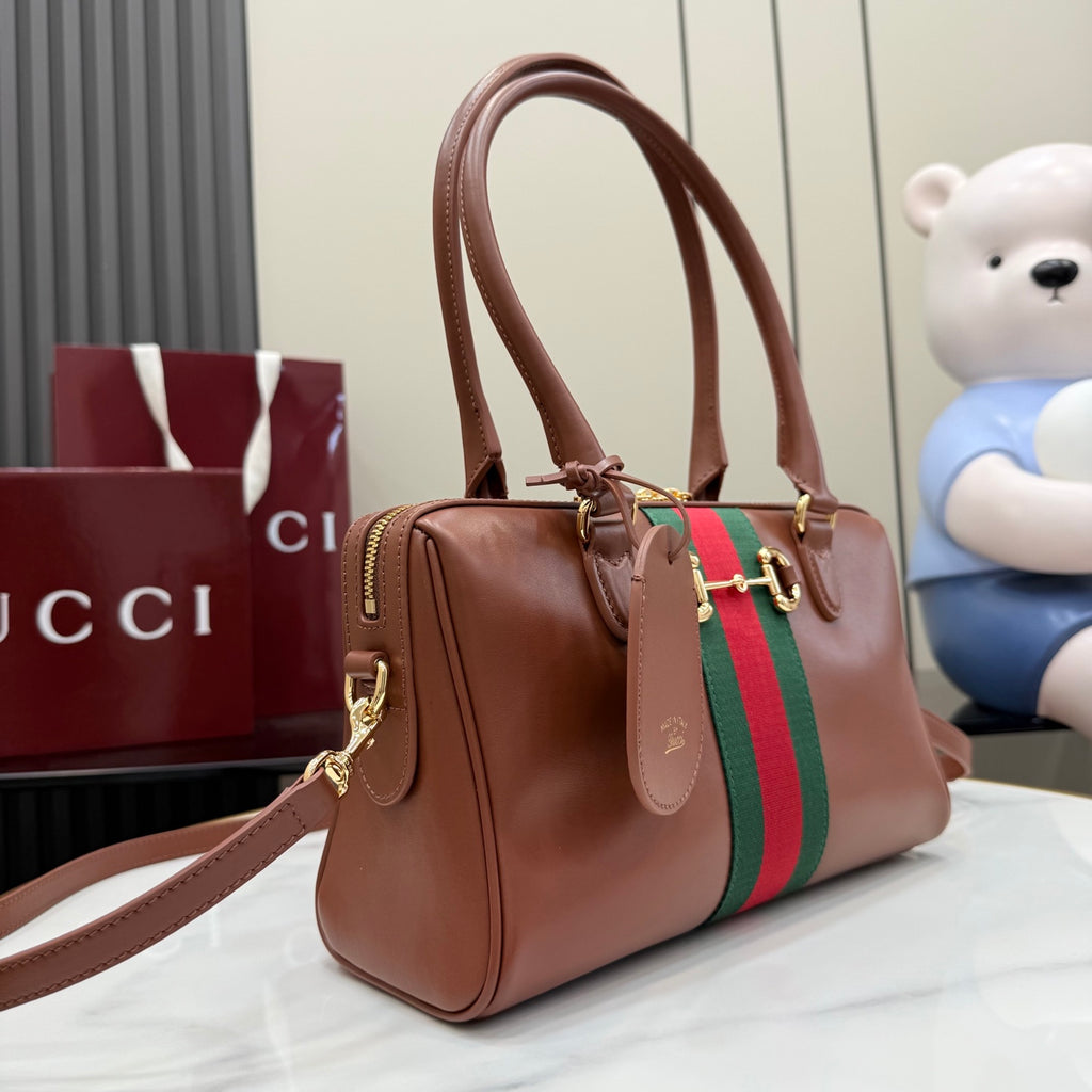 Brown leather handbag with top handles, green/red web stripe, gold-tone hardware.