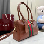 Brown leather handbag with top handles, green/red web stripe, gold-tone hardware.