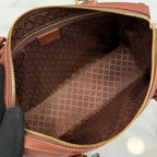 Zippered brown handbag interior with patterned fabric lining.
