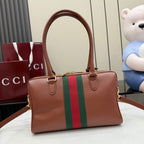 Brown leather handbag with green/red stripe and gold-tone top handles.