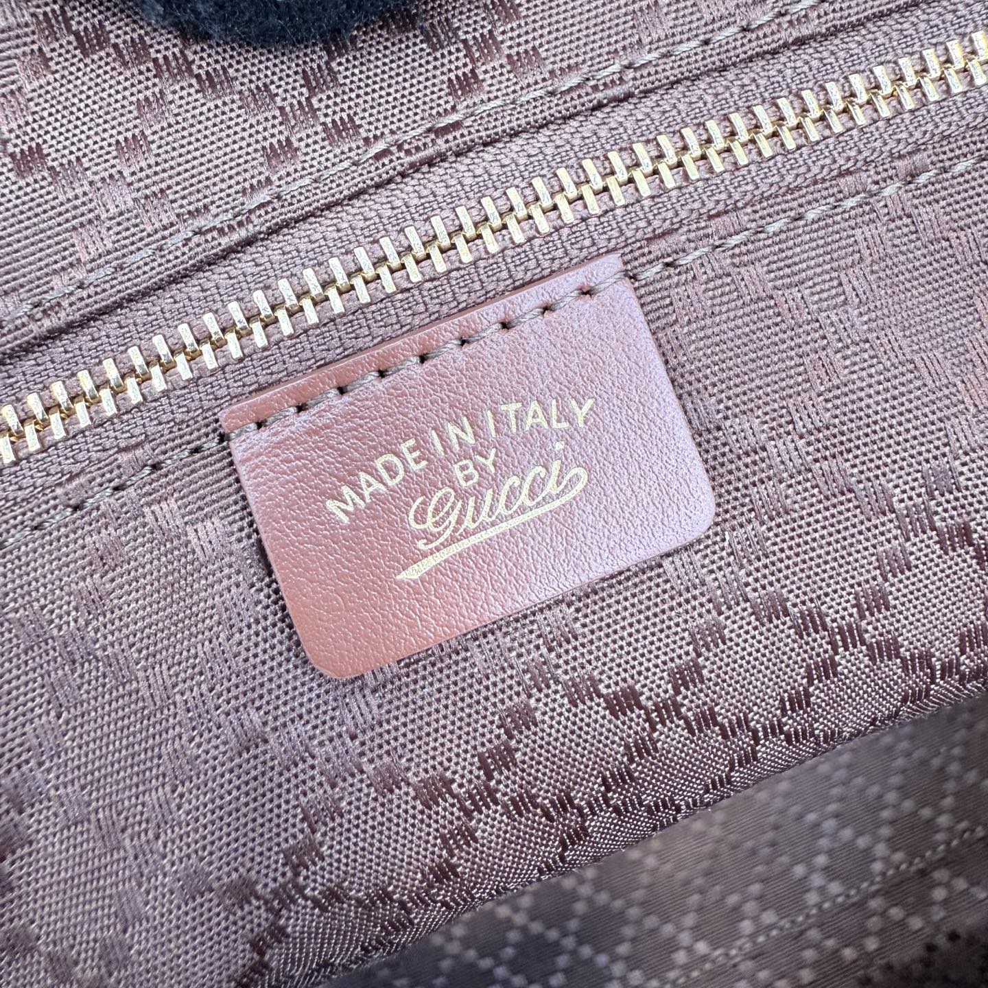 Gucci tote bag label reading "MADE IN ITALY" with Gucci logo on interior