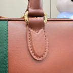 Gucci bag front strap tab with gold ring hardware and stitched detail