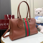Brown Gucci tote bag with green-and-red stripe, top handles, and crossbody strap