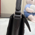Black leather top-handle section with stitched handle loops and silver-tone connector hardware