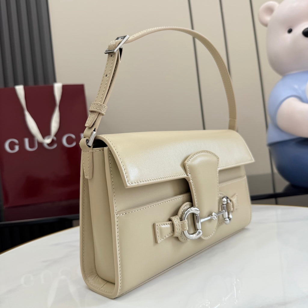 Gucci mini bag in light beige with top handle and front flap closure.