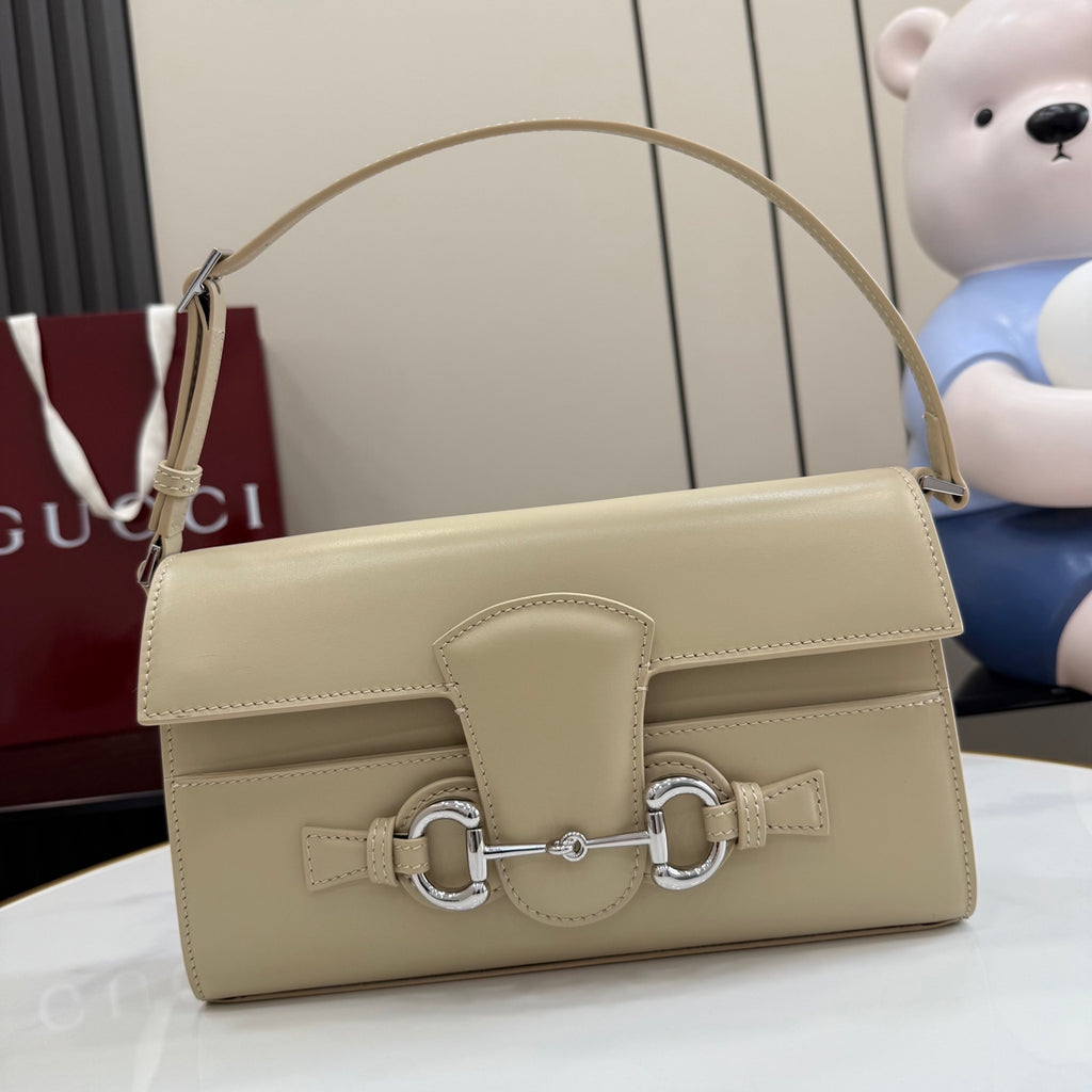 Gucci mini bag in light beige with front flap and metal clasp hardware.