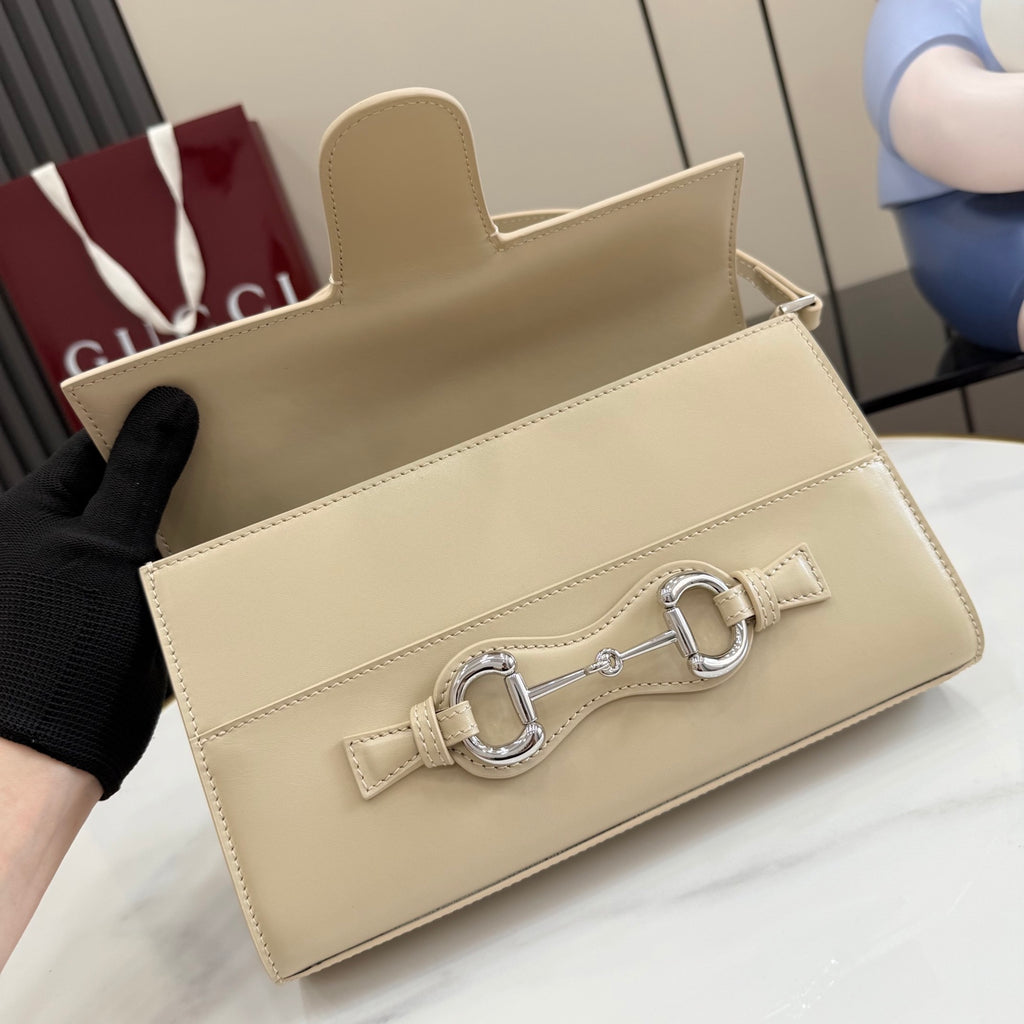 Gucci mini bag in light beige with open top flap and front bar clasp.