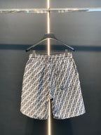 Dior logo-pattern shorts on hanger, full front view, navy and white print.
