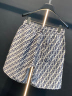 Dior logo-pattern shorts on hanger, side view showing pocket and side seam.