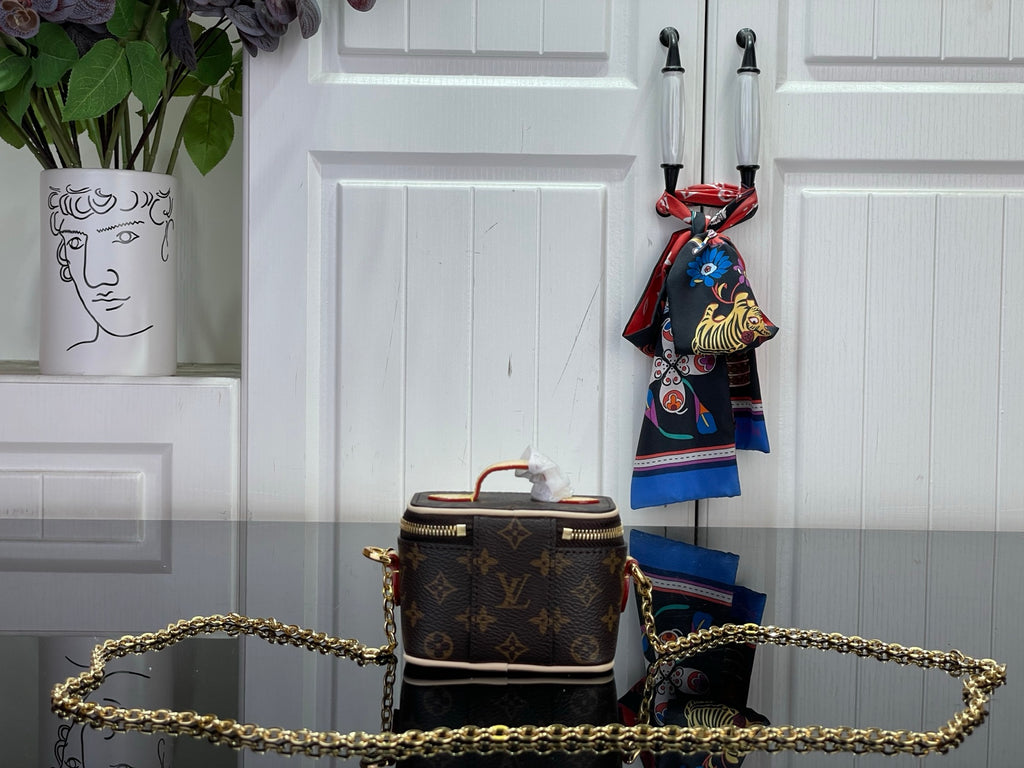 Monogram vanity bag with gold chain strap, top handle, brown canvas and multicolor scarf