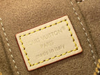 Leather brand tag on monogram bag reading Louis Vuitton Paris Made in Italy