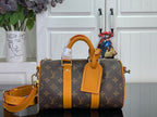 Louis Vuitton monogram handbag with orange leather handles and crossbody strap