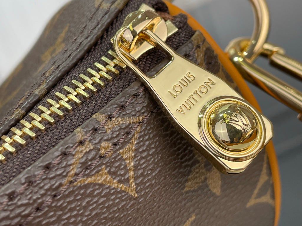 Louis Vuitton monogram bag zipper pull with gold charm and LV text