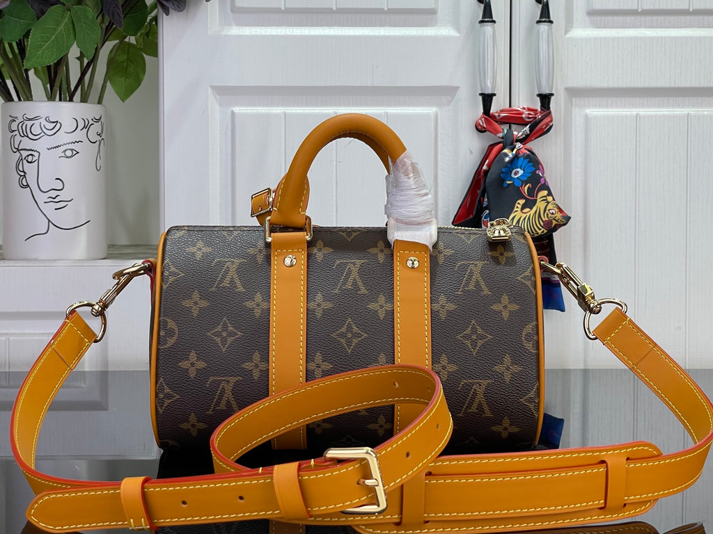 Louis Vuitton monogram handbag with orange strap, front pockets, and gold hardware
