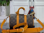 Louis Vuitton monogram handbag with orange strap, front pockets, and gold hardware