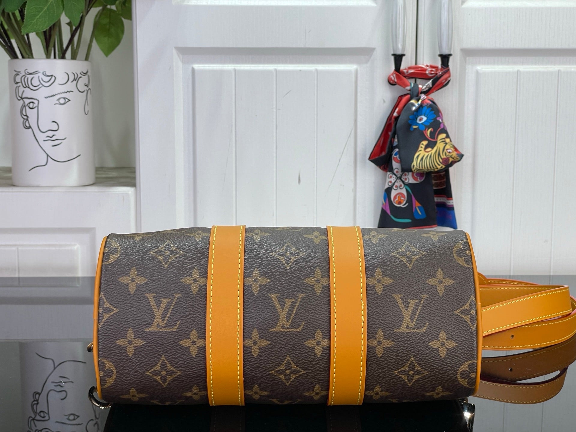 Louis Vuitton monogram duffel-style bag with wide orange trim and shoulder strap