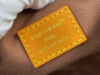 Louis Vuitton bag label with yellow leather tag and gold-toned text