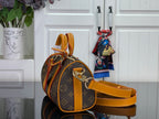 Louis Vuitton monogram handbag with orange leather strap and side profile view