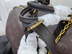Louis Vuitton bag strap and gold chain detail in dark monogram leather