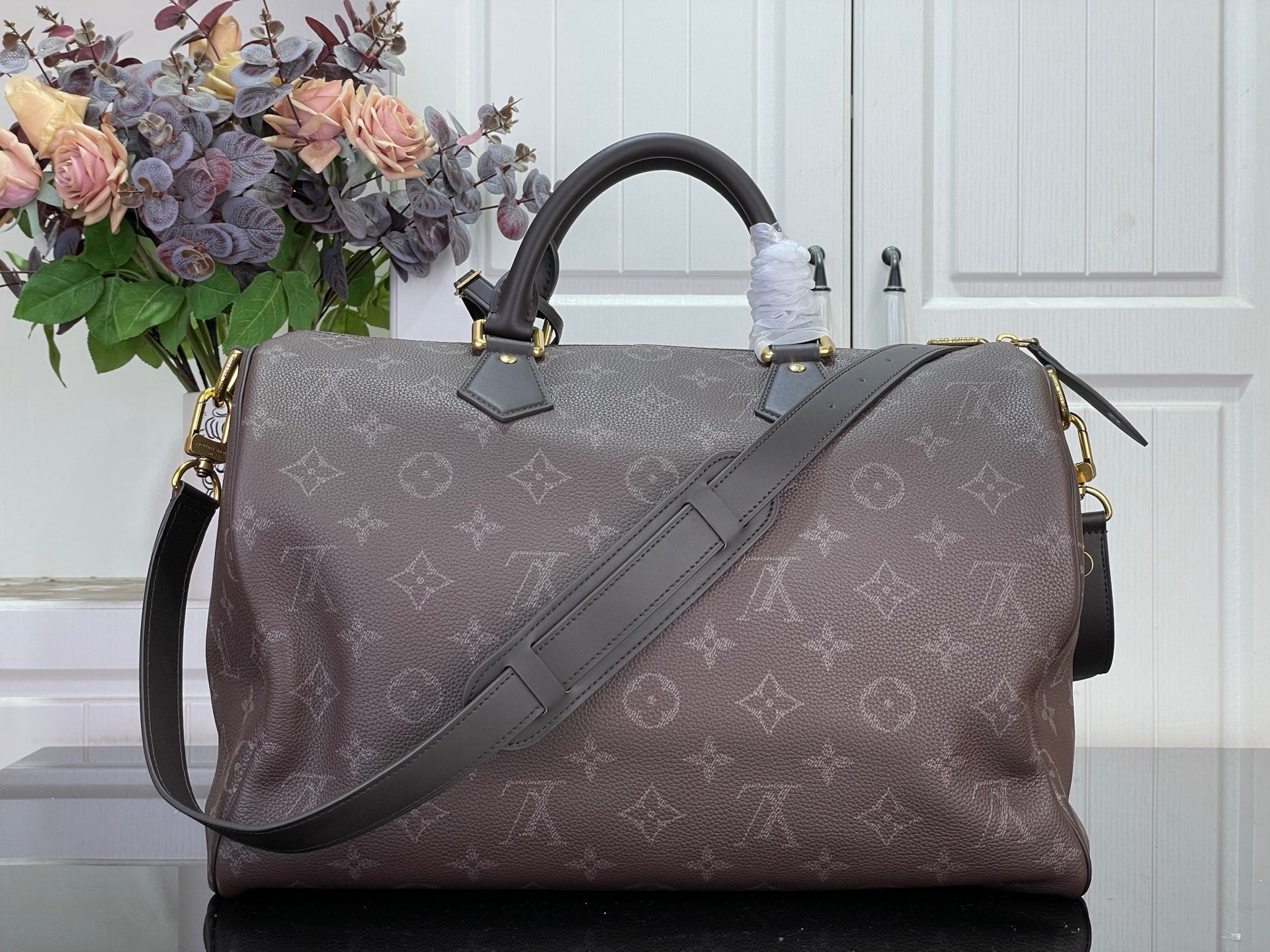 Louis Vuitton monogram tote bag with adjustable shoulder strap and top handles