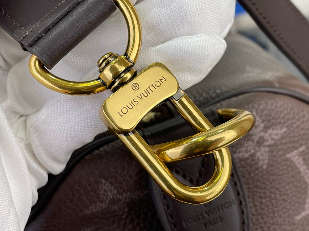 Louis Vuitton bag clasp lock hardware in gold tone with brand stamp