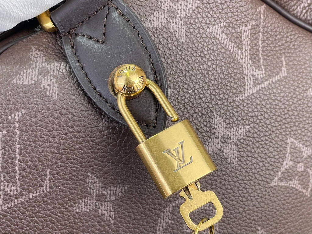 Louis Vuitton monogram bag key charm with gold padlock hardware and strap loop