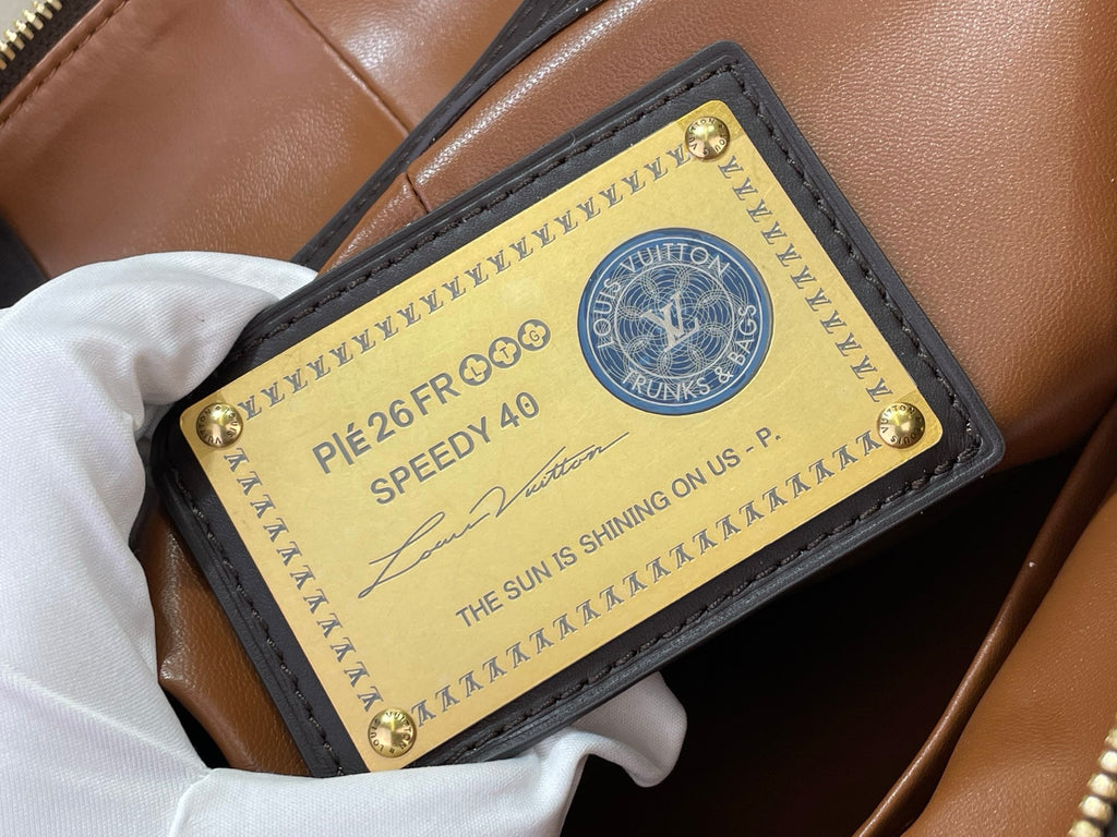 Louis Vuitton bag authenticity label card with text inside tan pocket lining