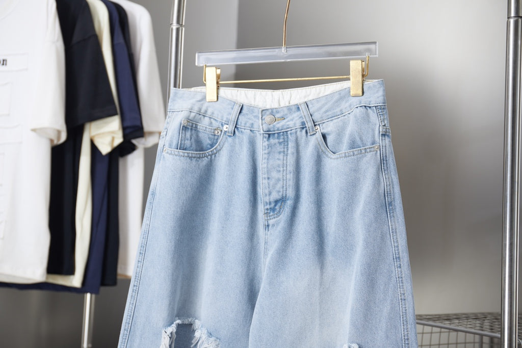 Light blue denim pants with front button closure and belt loops