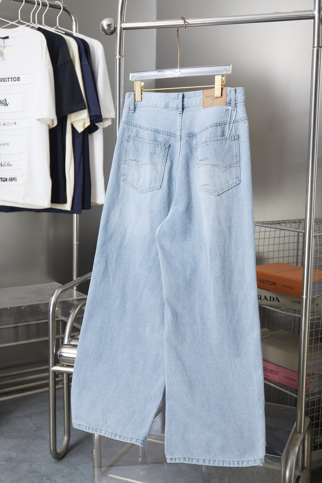 Light blue denim pants on hanger, button fly, large front patch pockets