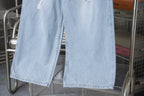 Light blue denim pants with wide leg and unfinished frayed hem