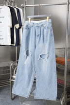 Balenciaga light blue denim pants with knee rips and wide leg