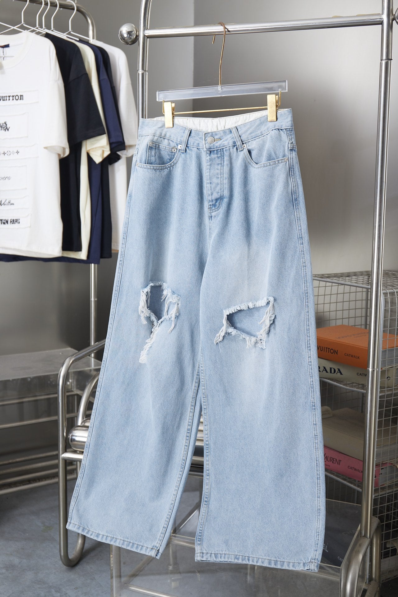 Balenciaga light blue denim pants with knee rips and wide leg