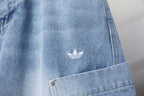Light blue denim pants with small white logo near the front pocket