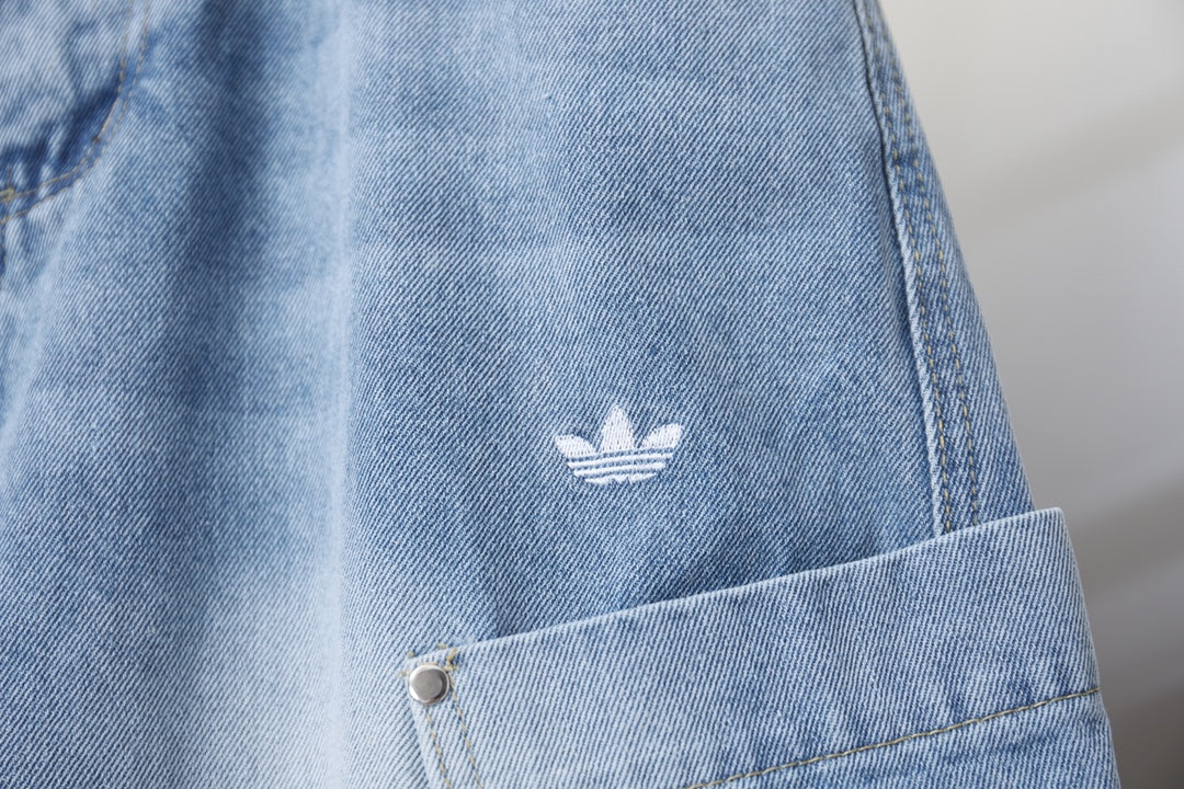 Light blue denim pants with small white logo near the front pocket