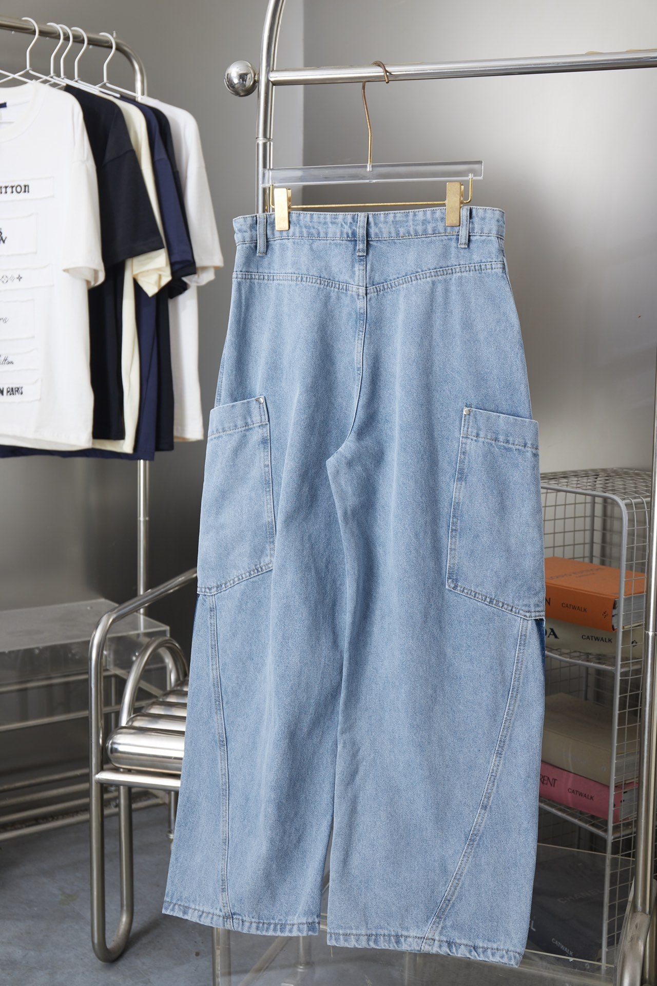 Light blue denim cargo pants with front pockets, belt loops, and button closure