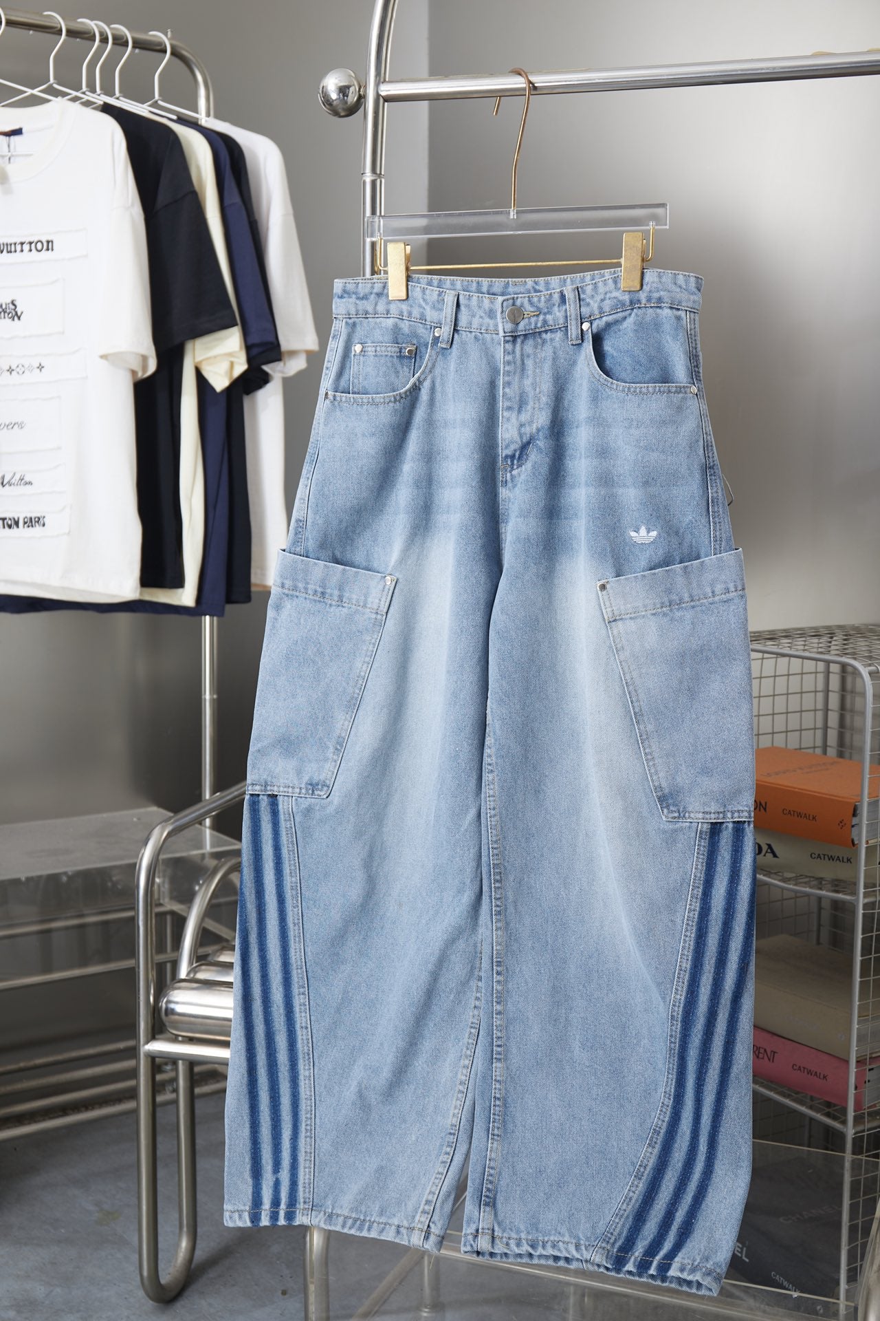 Light blue denim cargo pants with two front flap pockets and adjustable waistband
