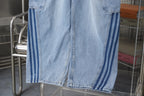 Light blue denim pants with striped side panels and stitched leg hem