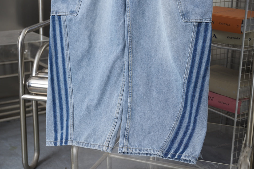 Light blue denim pants with striped side panels and stitched leg hem