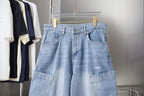 Light blue denim pants with front pockets, belt loops, and small chest logo