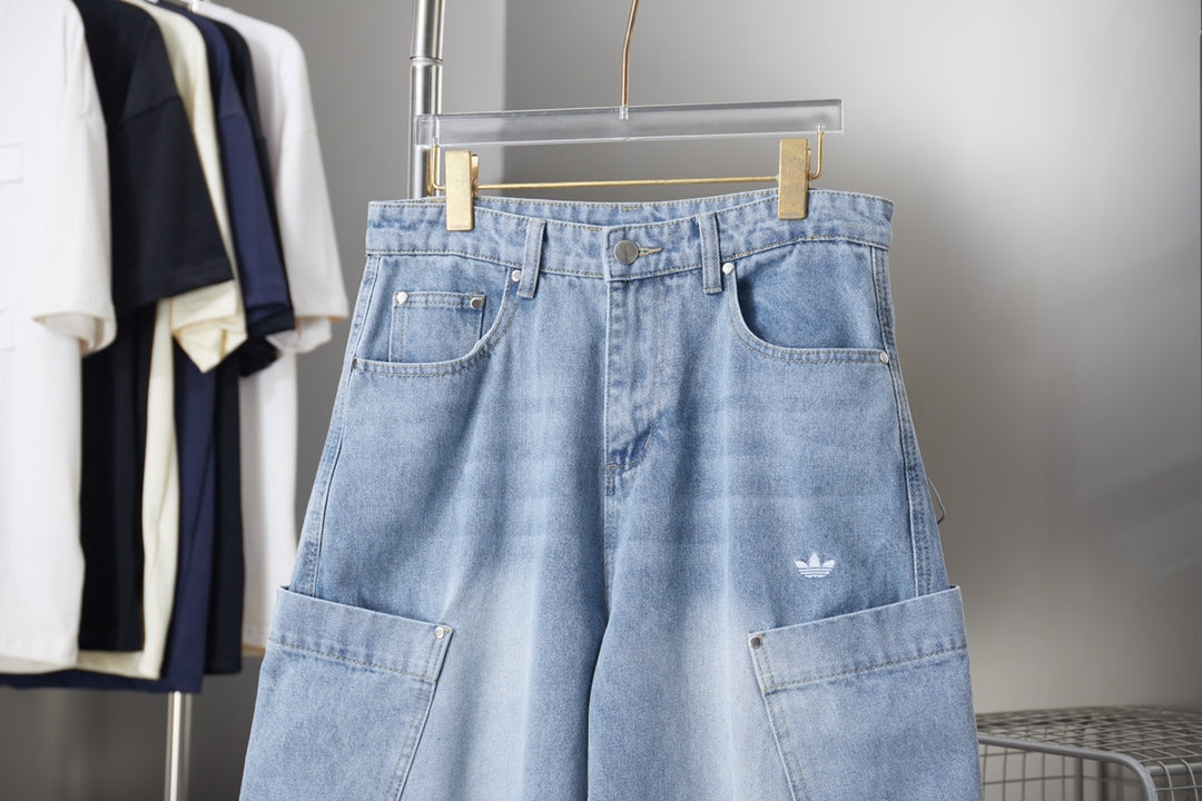Light blue denim pants with front pockets, belt loops, and small chest logo