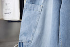 Light blue denim cargo pocket with button and angled seam detail