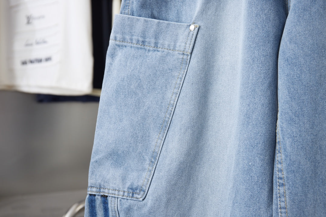 Light blue denim cargo pocket with button and angled seam detail