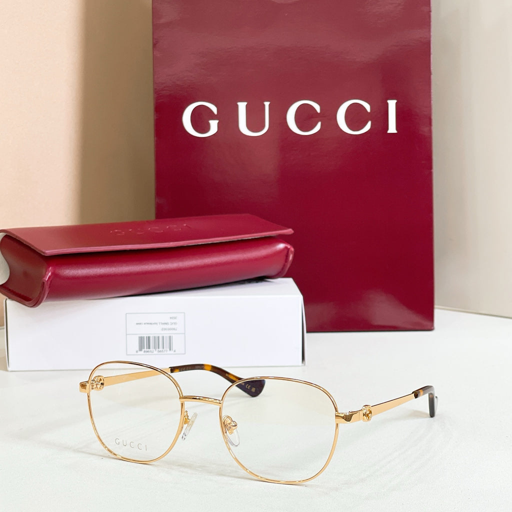 Gucci eyeglasses with gold round frame and dark temple tips