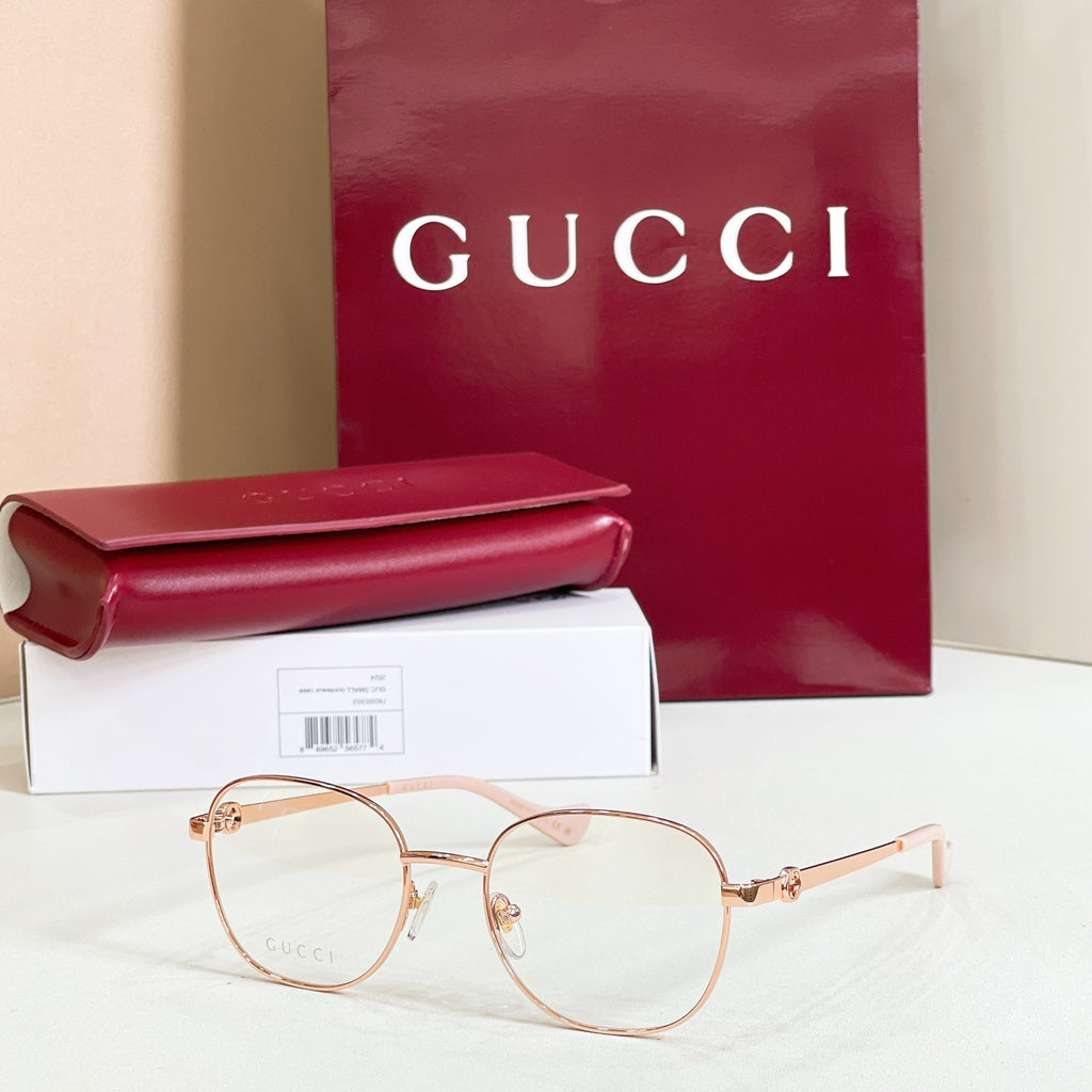 Gucci eyeglasses with rose gold round frame and light pink temple tips
