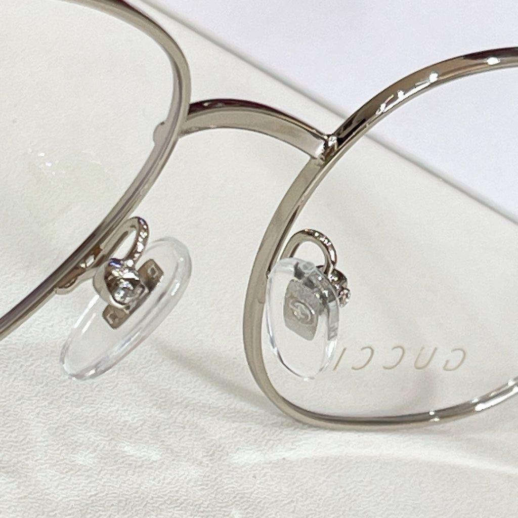 Gucci eyeglasses frame close-up with silver round rims and clear lenses