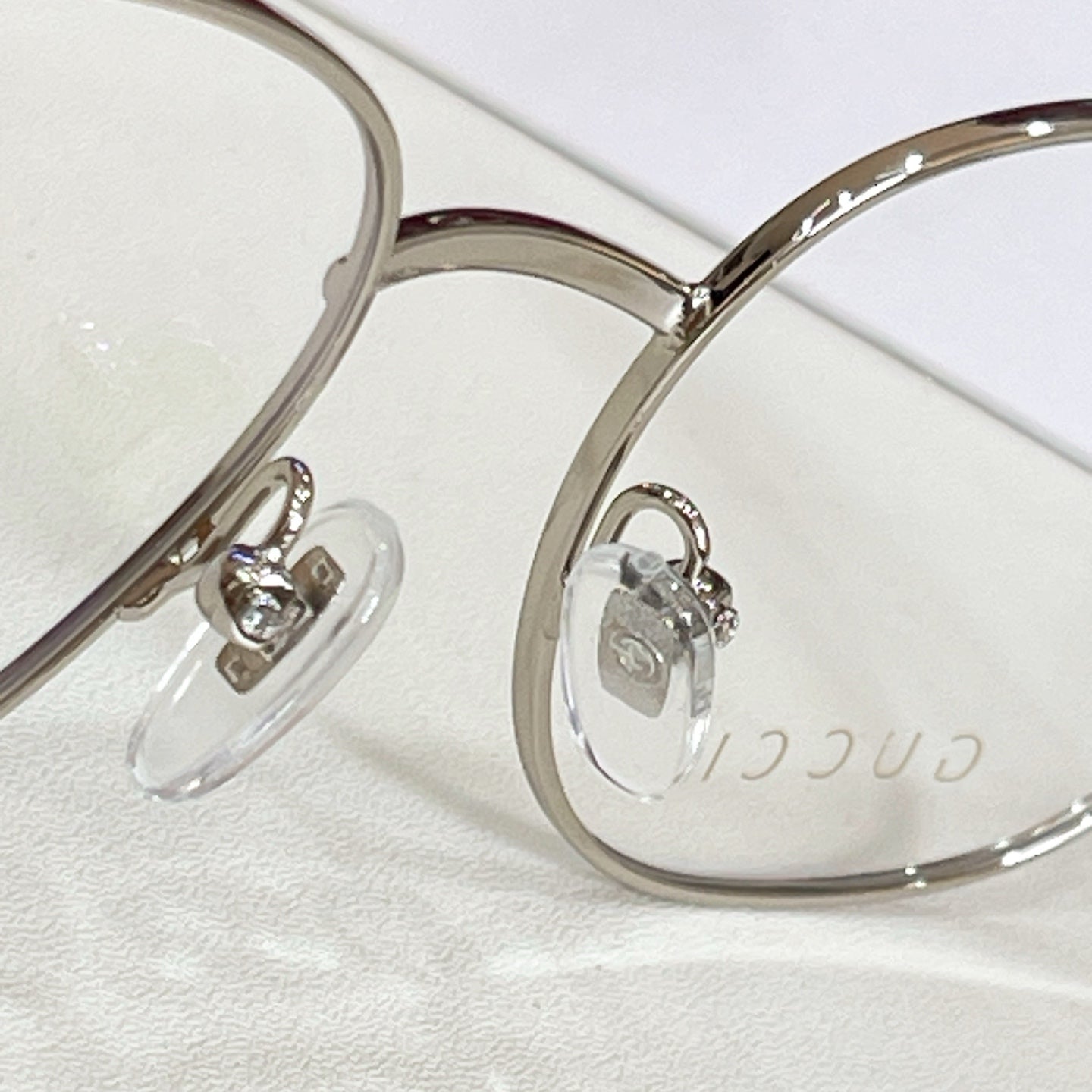 Gucci eyeglasses frame close-up with silver round rims and clear lenses